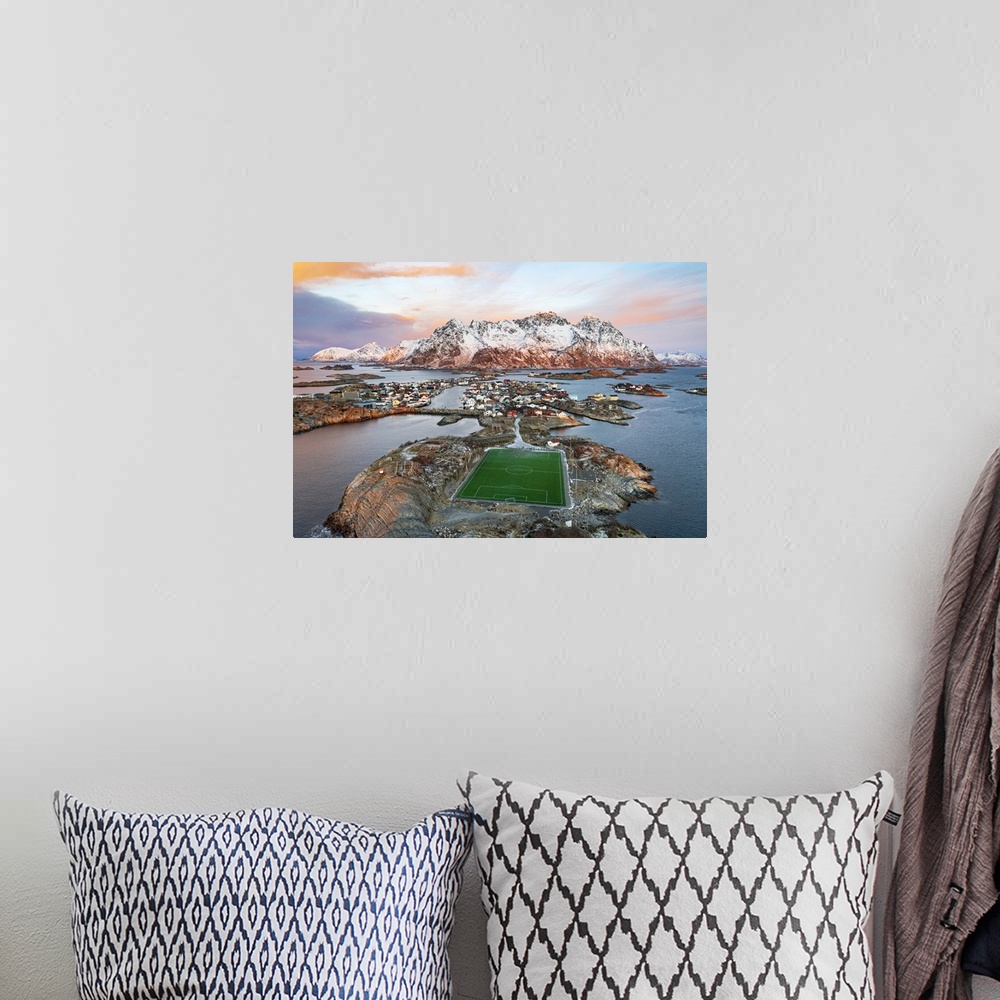 A bohemian room featuring Aerial view of soccer stadium and Henningsvaer village during winter dawn, Nordland county, Lofot...