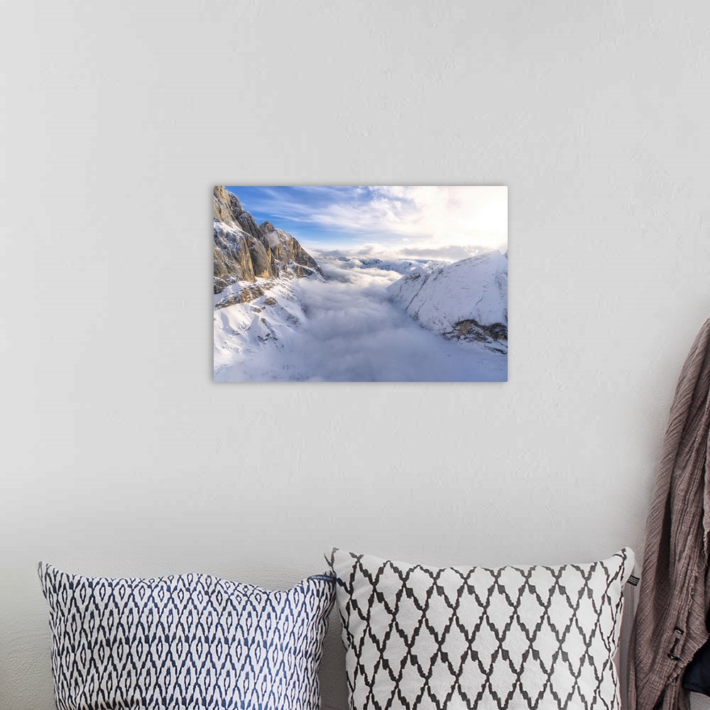 A bohemian room featuring Aerial view of Valle Ombretta covered by clouds from Marmolada, Dolomites, Veneto, Italy, Europe
