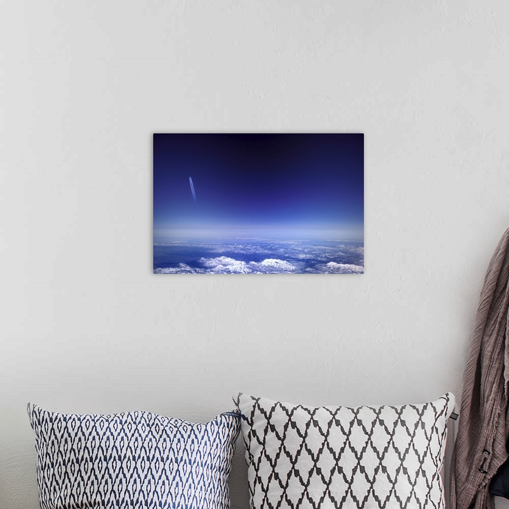 A bohemian room featuring Aircraft vapour trails above clouds over Colorado