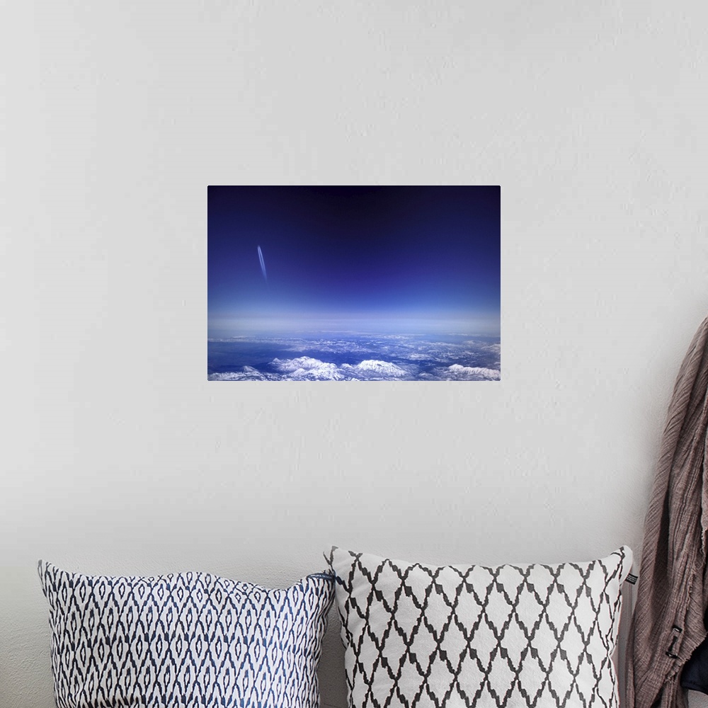 A bohemian room featuring Aircraft vapour trails above clouds over Colorado