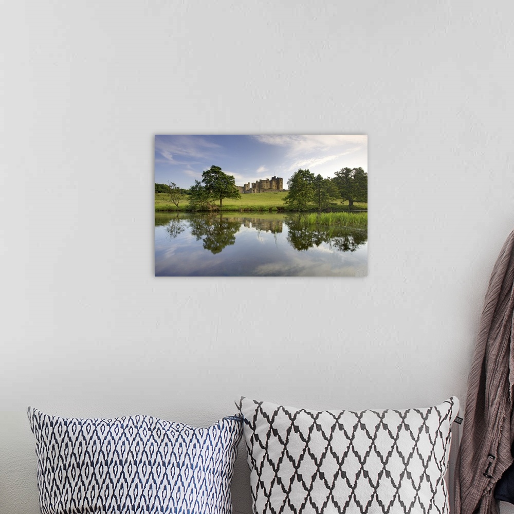 A bohemian room featuring Alnwick Castle reflecting in River Aln, Alnwick, Northumberland, England