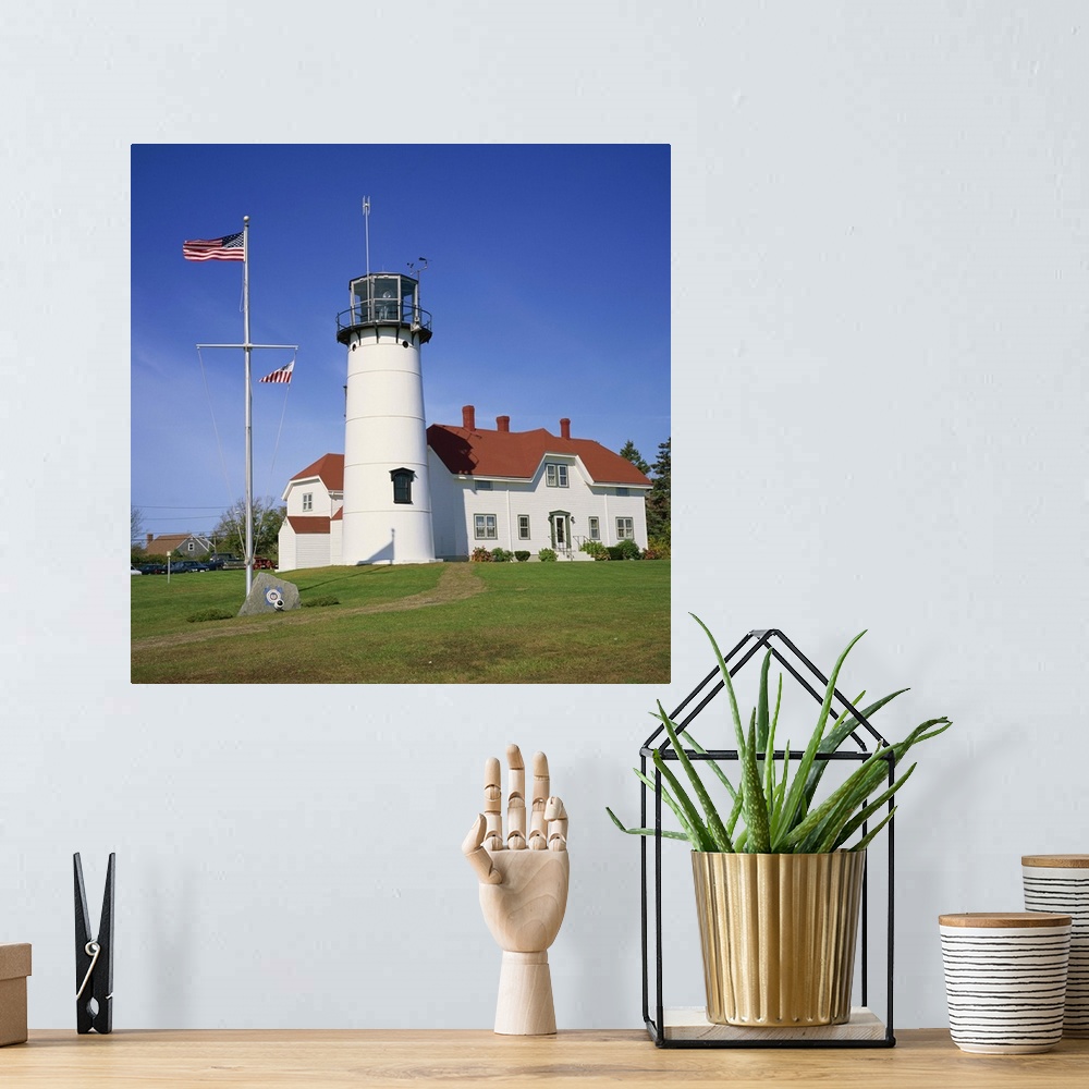 A bohemian room featuring American flag flying beside the Chatham lighthouse, Cape Cod, Massachusetts