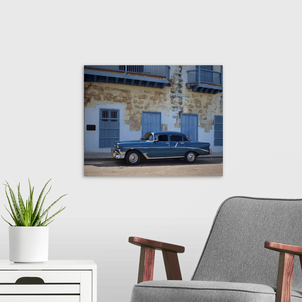 A modern room featuring An old blue Chevrolet car parked in a street in Old Havana, Cuba, Caribbean