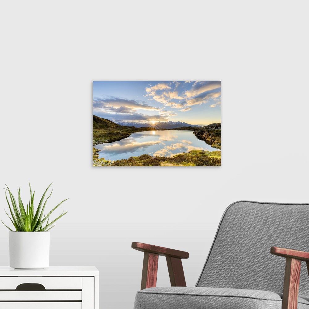 A modern room featuring The sun and clouds reflected in the Arcoglio Lake at sunrise, Valmalenco, Valtellina, Lombardy, I...