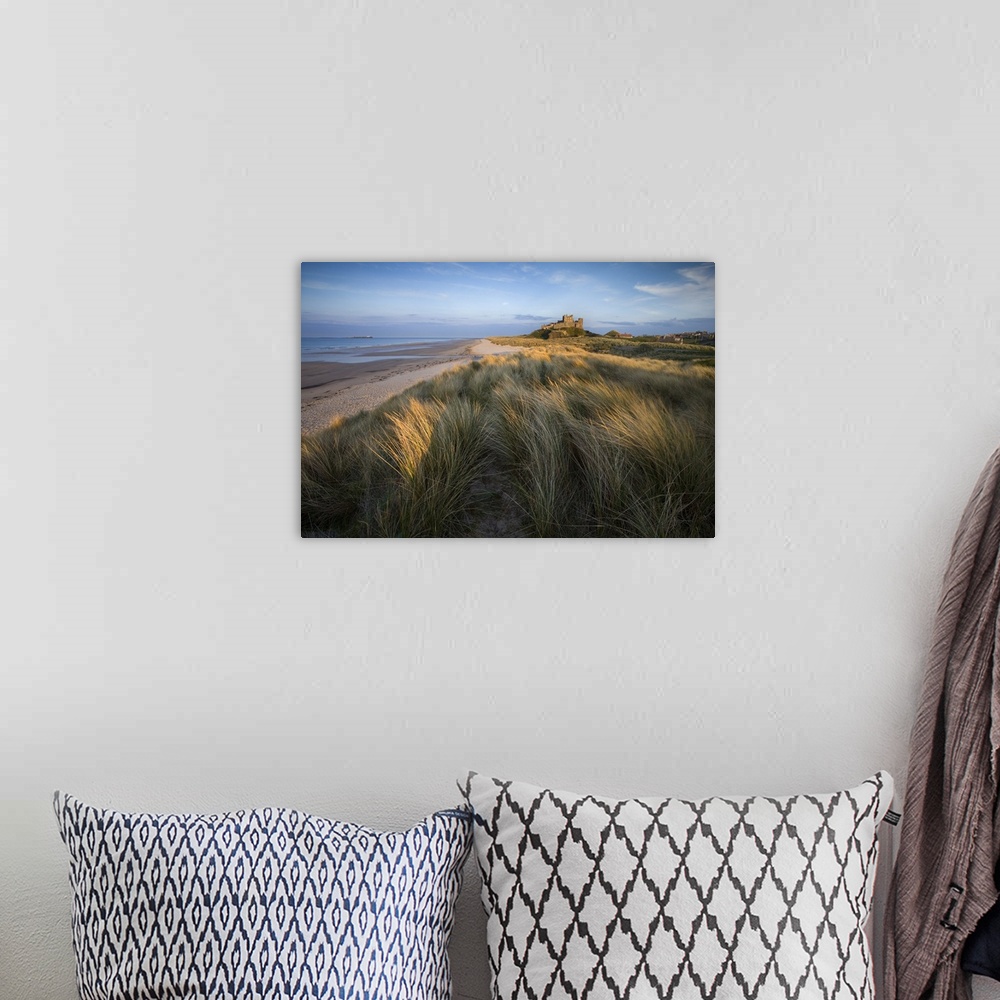 A bohemian room featuring Looking towards Bamburgh Castle bathed in evening light from the dunes above Bamburgh Beach, Bamb...