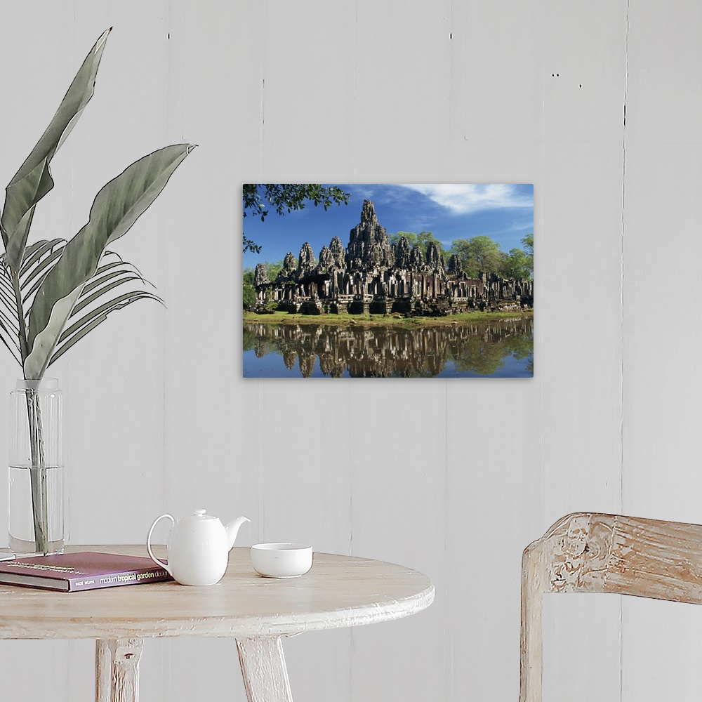 A farmhouse room featuring Bayon Temple reflected in water at Angkor, Siem Reap, Cambodia, Indochina