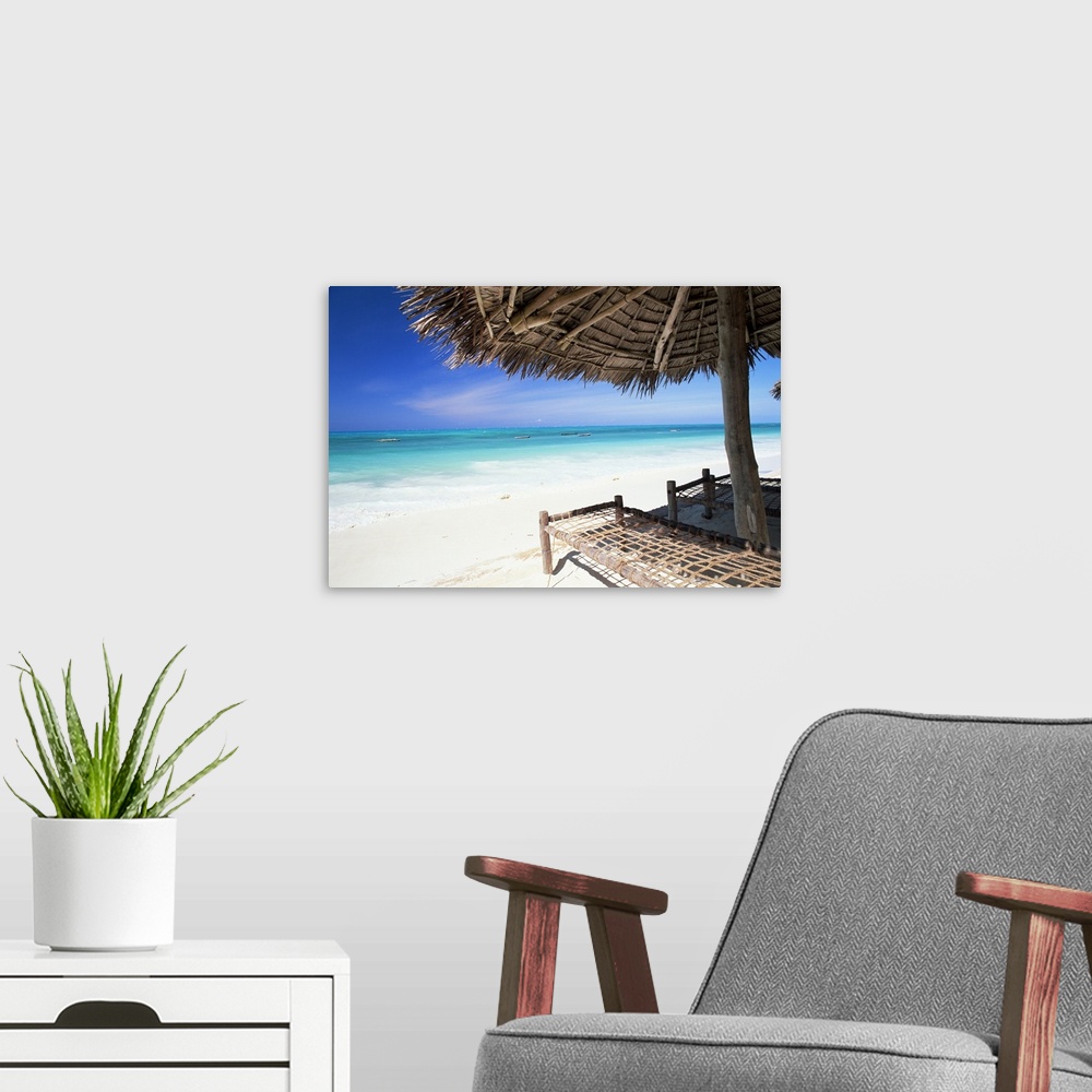 A modern room featuring Beach parasol overlooking Indian Ocean, island of Zanzibar, Tanzania, Africa