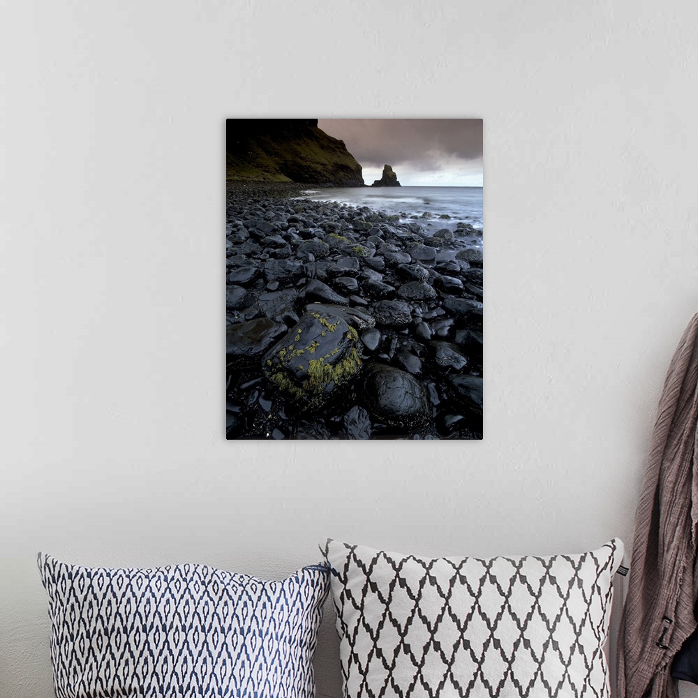 A bohemian room featuring Black boulder rocks in Talisker Bay, Isle of Skye, Inner Hebrides, Scotland, UK