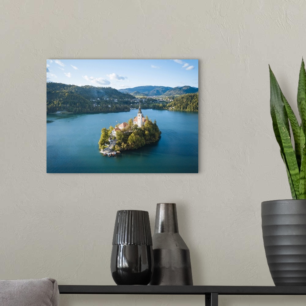 A modern room featuring Aerial view by drone of Bled Island with the Church of the Assumption at dawn, Lake Bled, Upper C...
