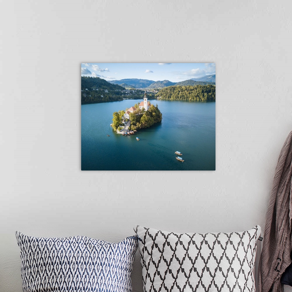 A bohemian room featuring Aerial view by drone of Bled Island with the Church of the Assumption at dawn, Lake Bled, Upper C...