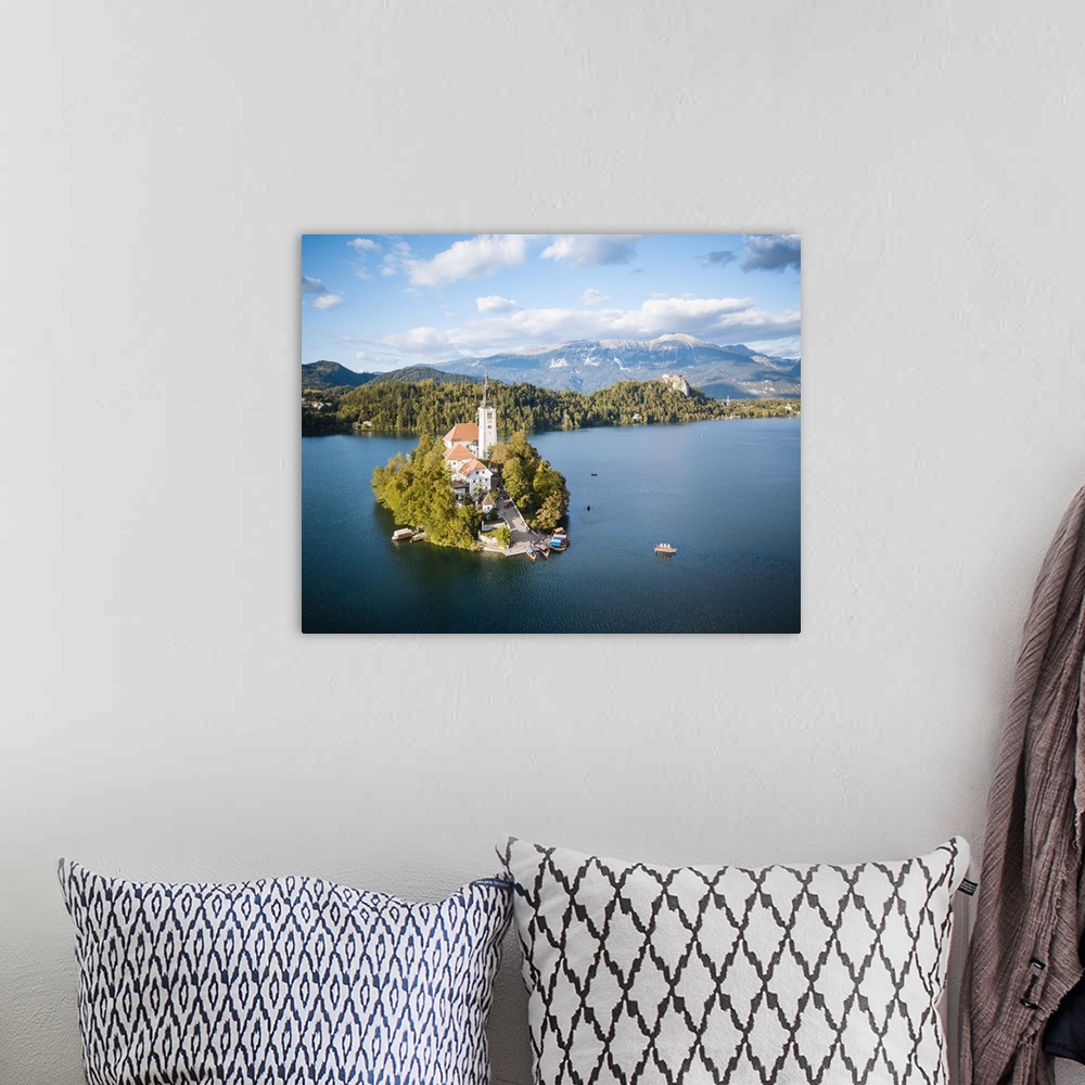 A bohemian room featuring Aerial view by drone of Bled Island with the Church of the Assumption at dawn, Lake Bled, Upper C...