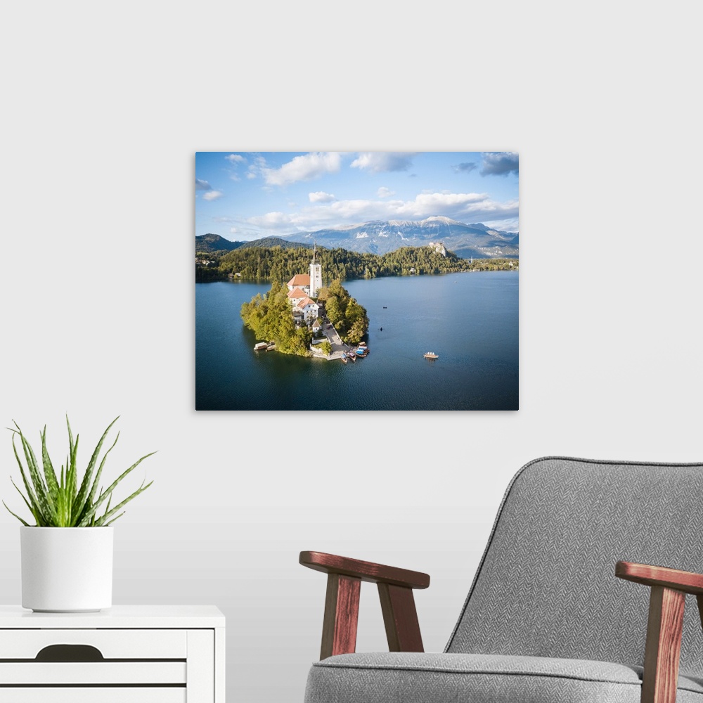 A modern room featuring Aerial view by drone of Bled Island with the Church of the Assumption at dawn, Lake Bled, Upper C...