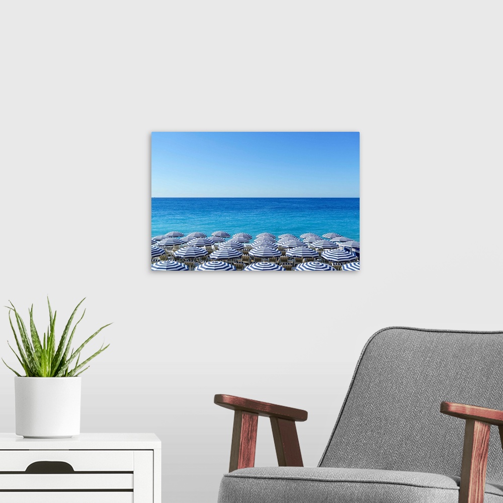 A modern room featuring Blue and white beach parasols, Nice, Cote d'Azur, Alpes-Maritimes, Provence, French Riviera, Fran...