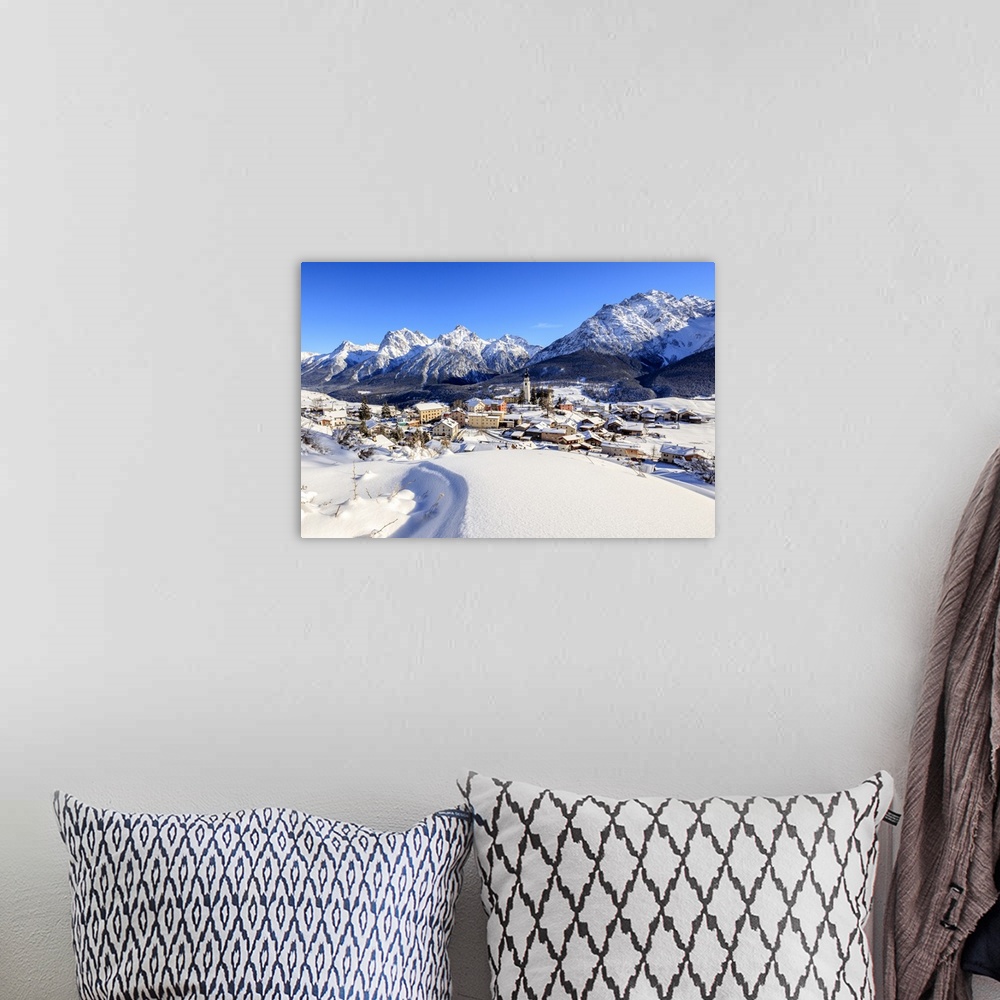 A bohemian room featuring Blue sky on the alpine village of Ftan surrounded by snow, Inn district, Canton of Graubunden, En...