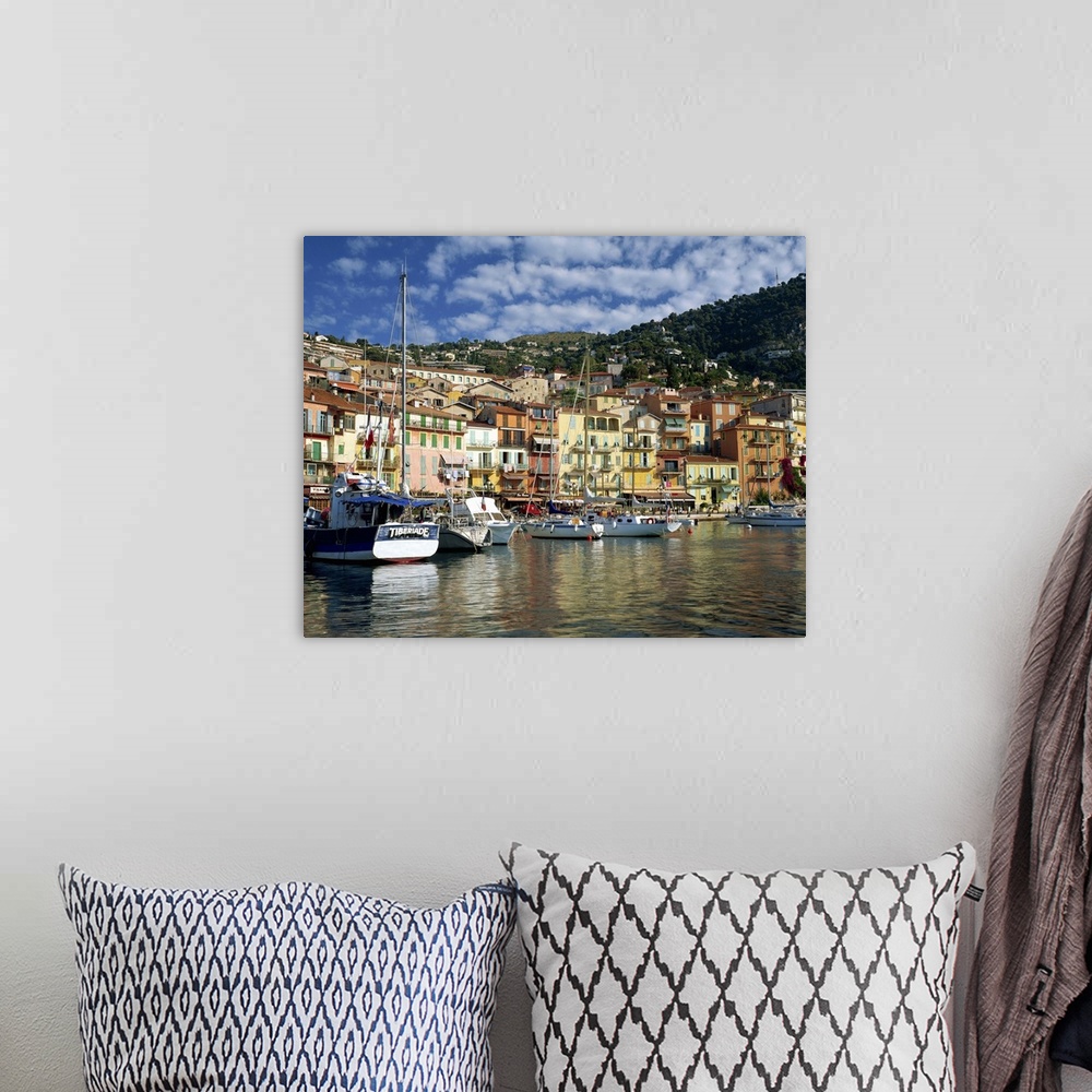 A bohemian room featuring Boats in the harbour and painted houses on the waterfront, Provence, France