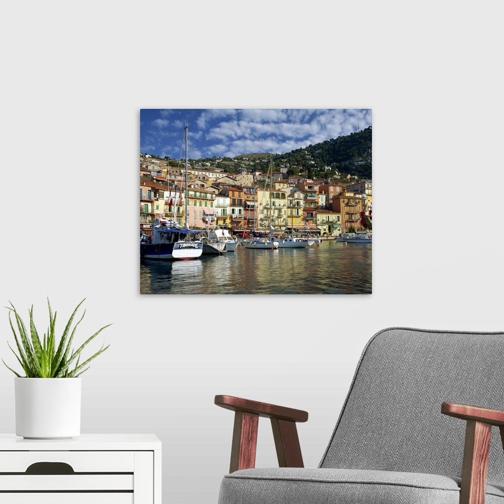 A modern room featuring Boats in the harbour and painted houses on the waterfront, Provence, France