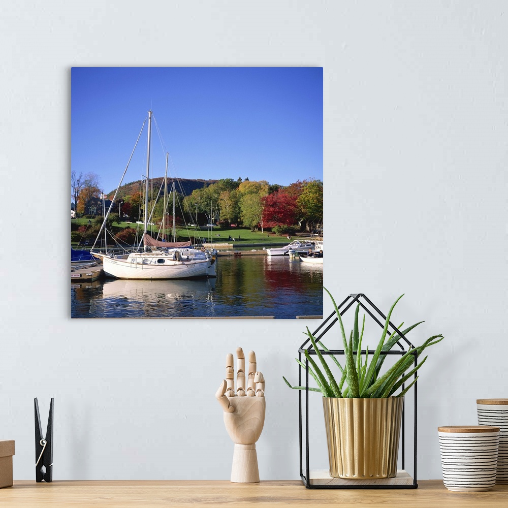 A bohemian room featuring Boats on waterfront at Camden harbour with Mount Battie, Maine, USA