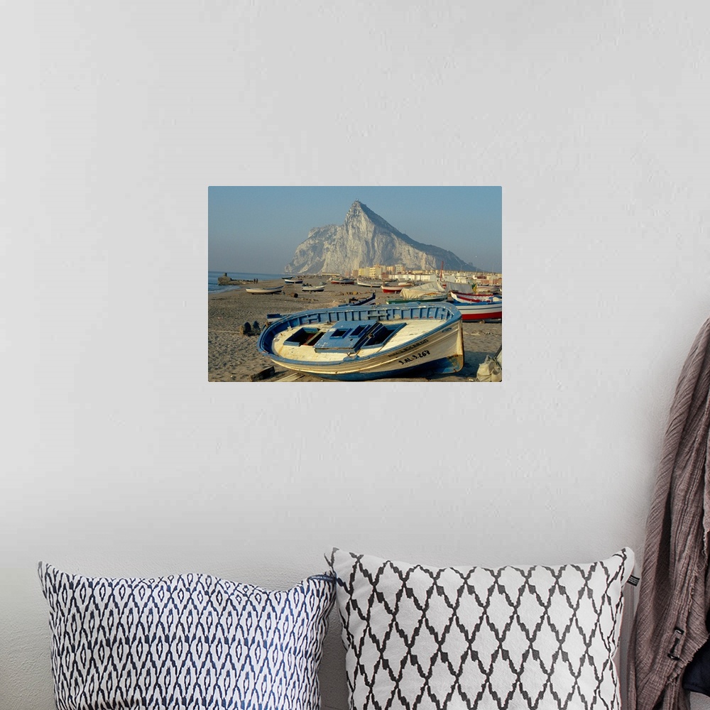 A bohemian room featuring Boats pulled onto beach below the Rock of Gibraltar, Gibraltar