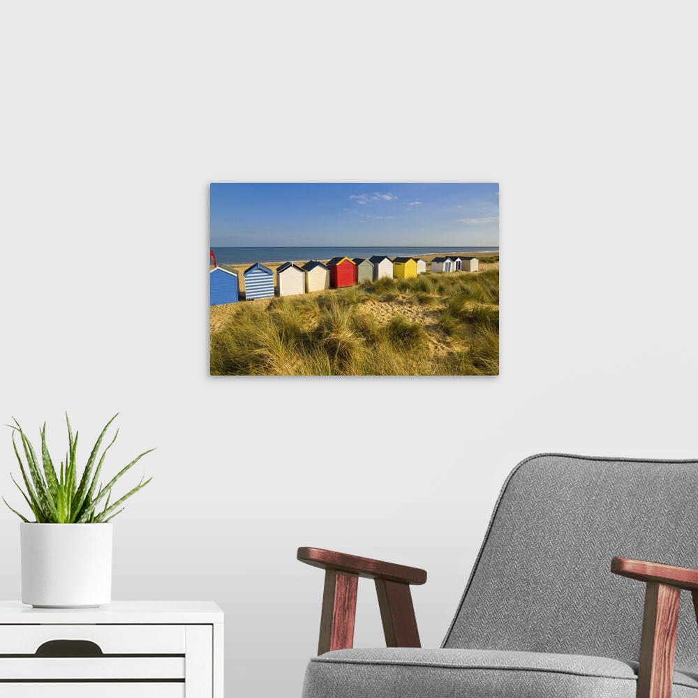 A modern room featuring Brightly painted beach huts, Southwold, Suffolk, England