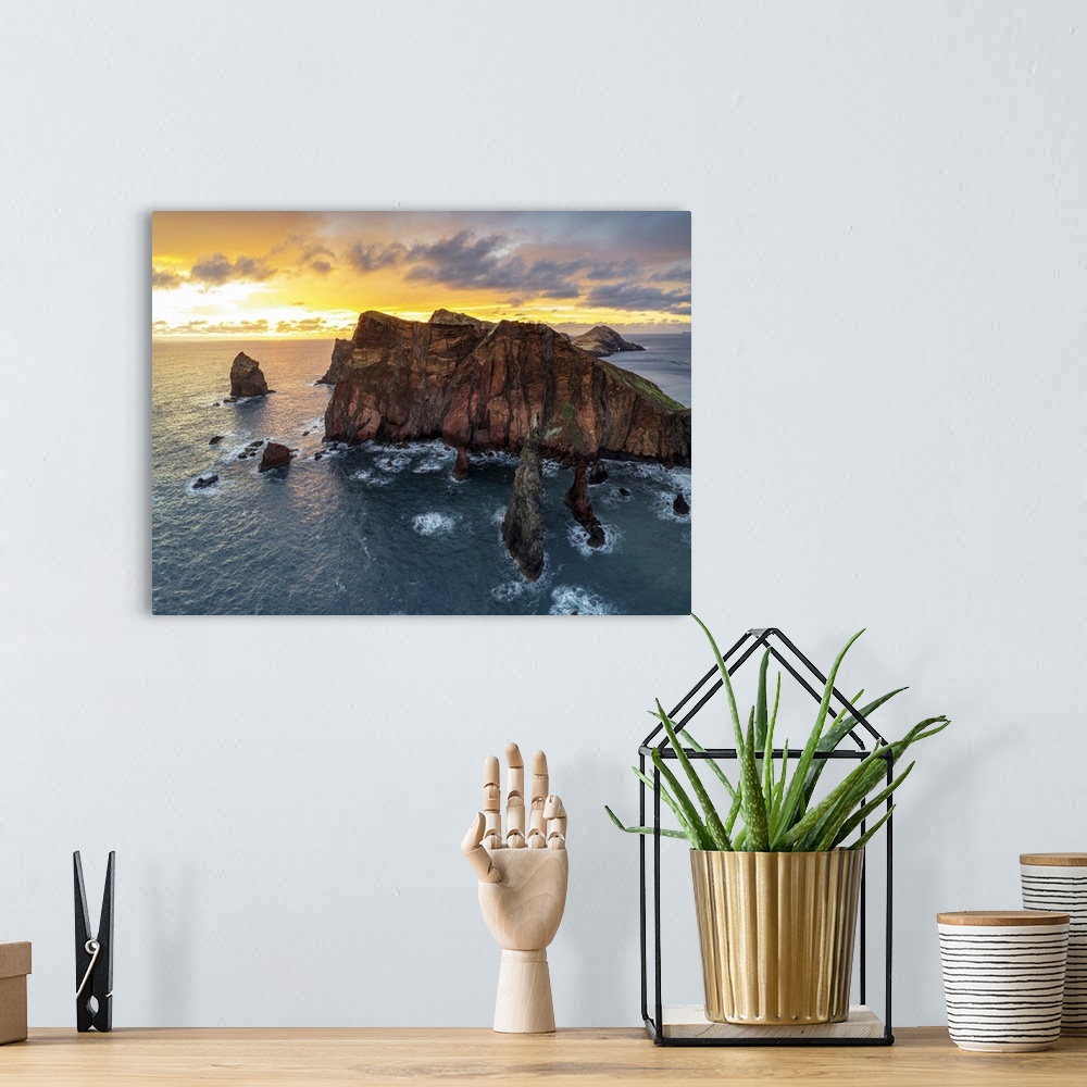 A bohemian room featuring Burning sky at dawn on cliffs washed by ocean, Ponta do Rosto viewpoint, Sao Lourenco Peninsula, ...