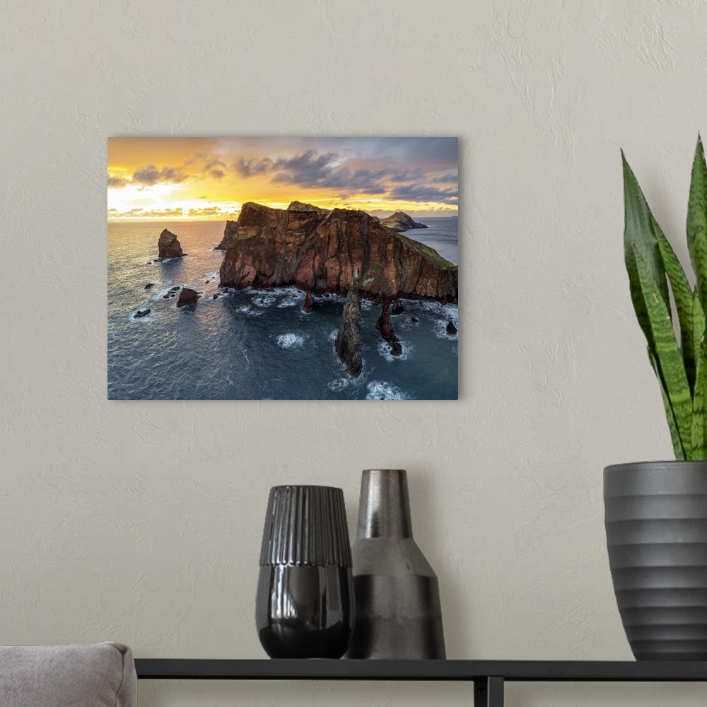A modern room featuring Burning sky at dawn on cliffs washed by ocean, Ponta do Rosto viewpoint, Sao Lourenco Peninsula, ...