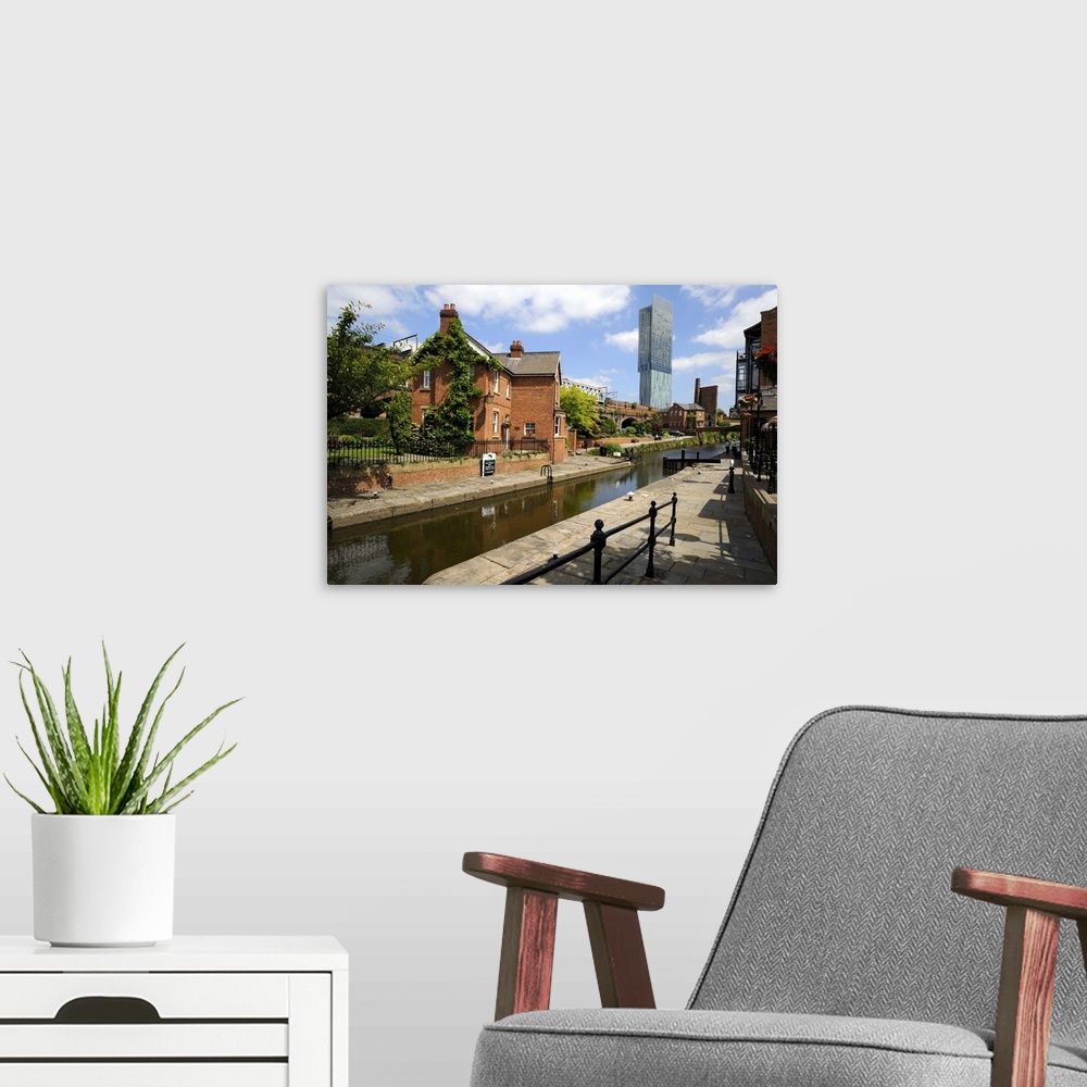 A modern room featuring Canal and lock keepers cottage with the Beetham Tower, Manchester, England