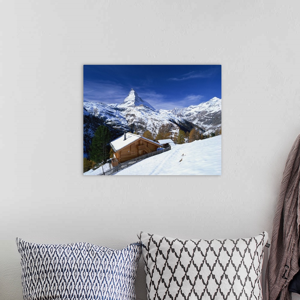 A bohemian room featuring Chalets in a snowy landscape with the Matterhorn peak, Swiss Alps, Switzerland