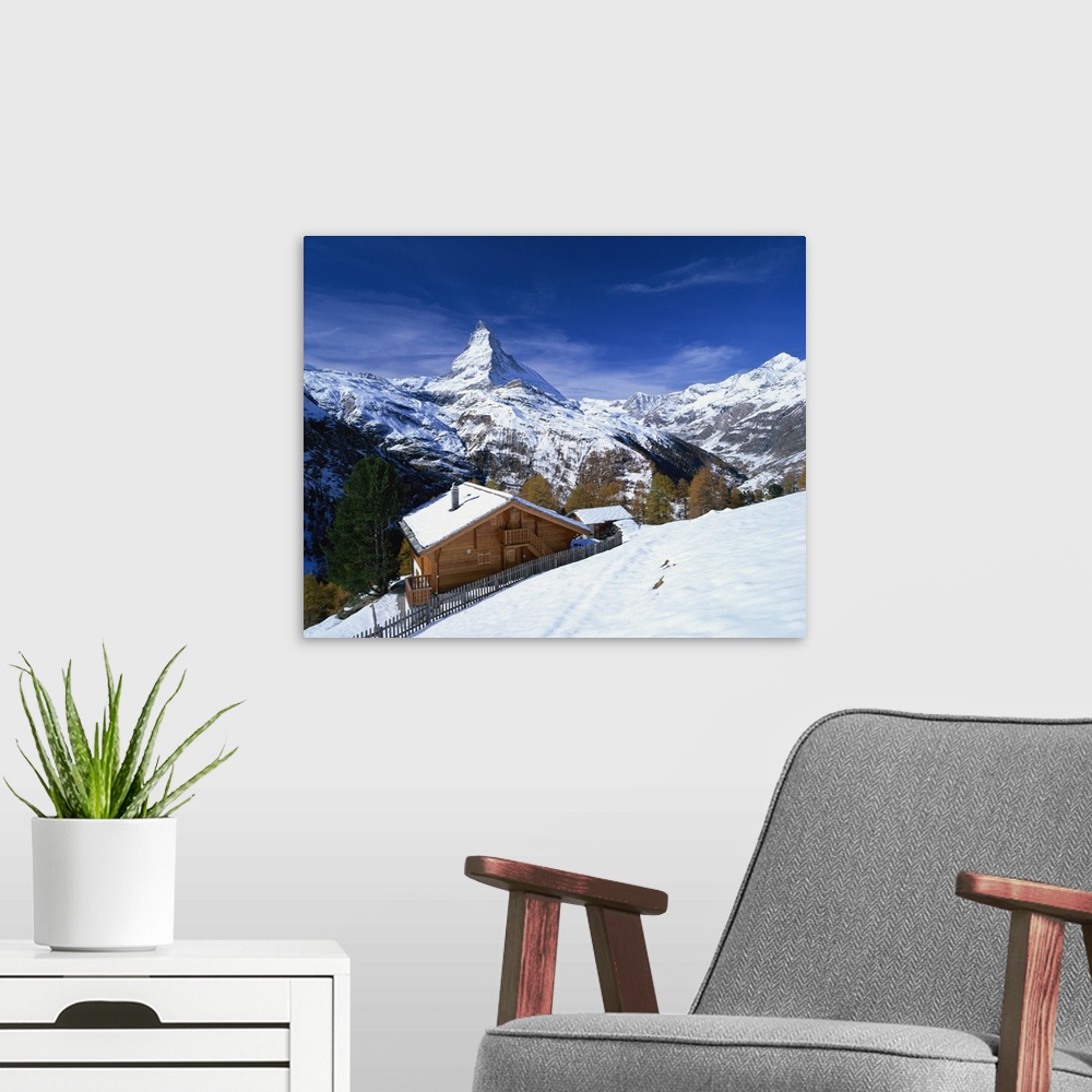 A modern room featuring Chalets in a snowy landscape with the Matterhorn peak, Swiss Alps, Switzerland