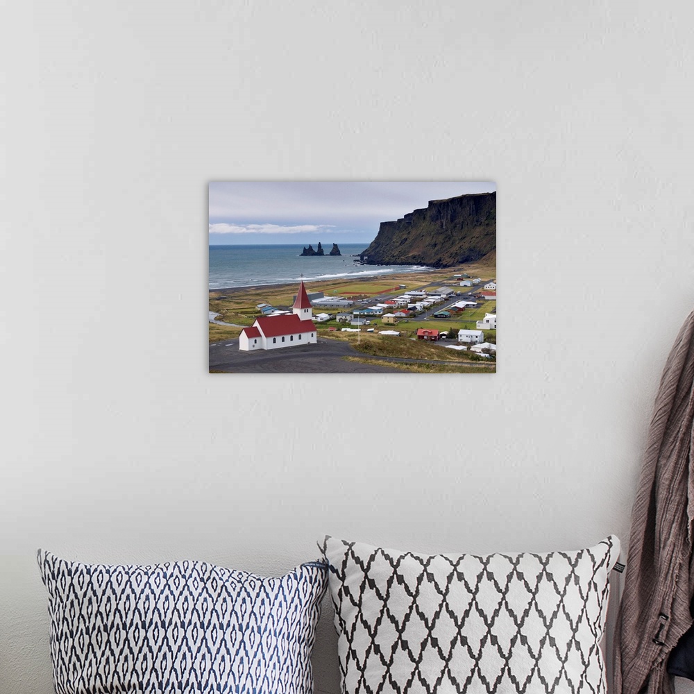 A bohemian room featuring Church, village of Vik and Reynisdrangar sea stacks in the distance, Iceland