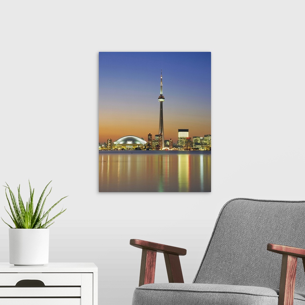 A modern room featuring City skyline including CN Tower in the evening, Toronto, Ontario, Canada