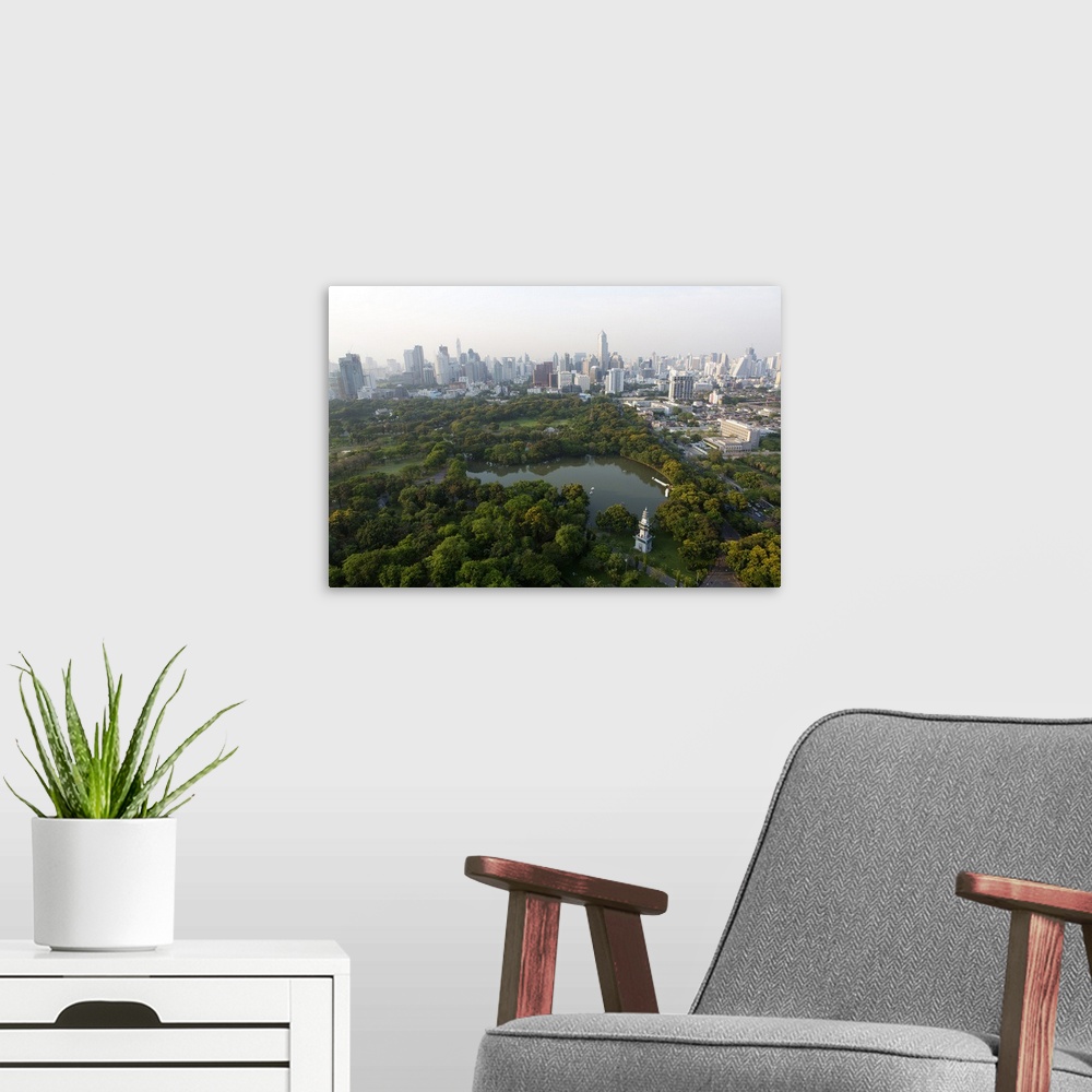A modern room featuring City skyline with Lumphini Park, the Green Lung of Bangkok, in the foreground, from the roof of H...