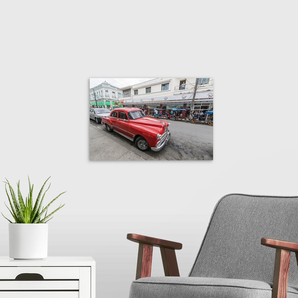 A modern room featuring Classic 1950s Pontiac taxi, locally known as almendrones in the town of Cienfuegos, Cuba, West In...