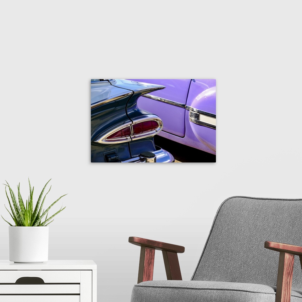 A modern room featuring Close-up view of two colorful vintage cars, Havana, Cuba, West Indies, Central America