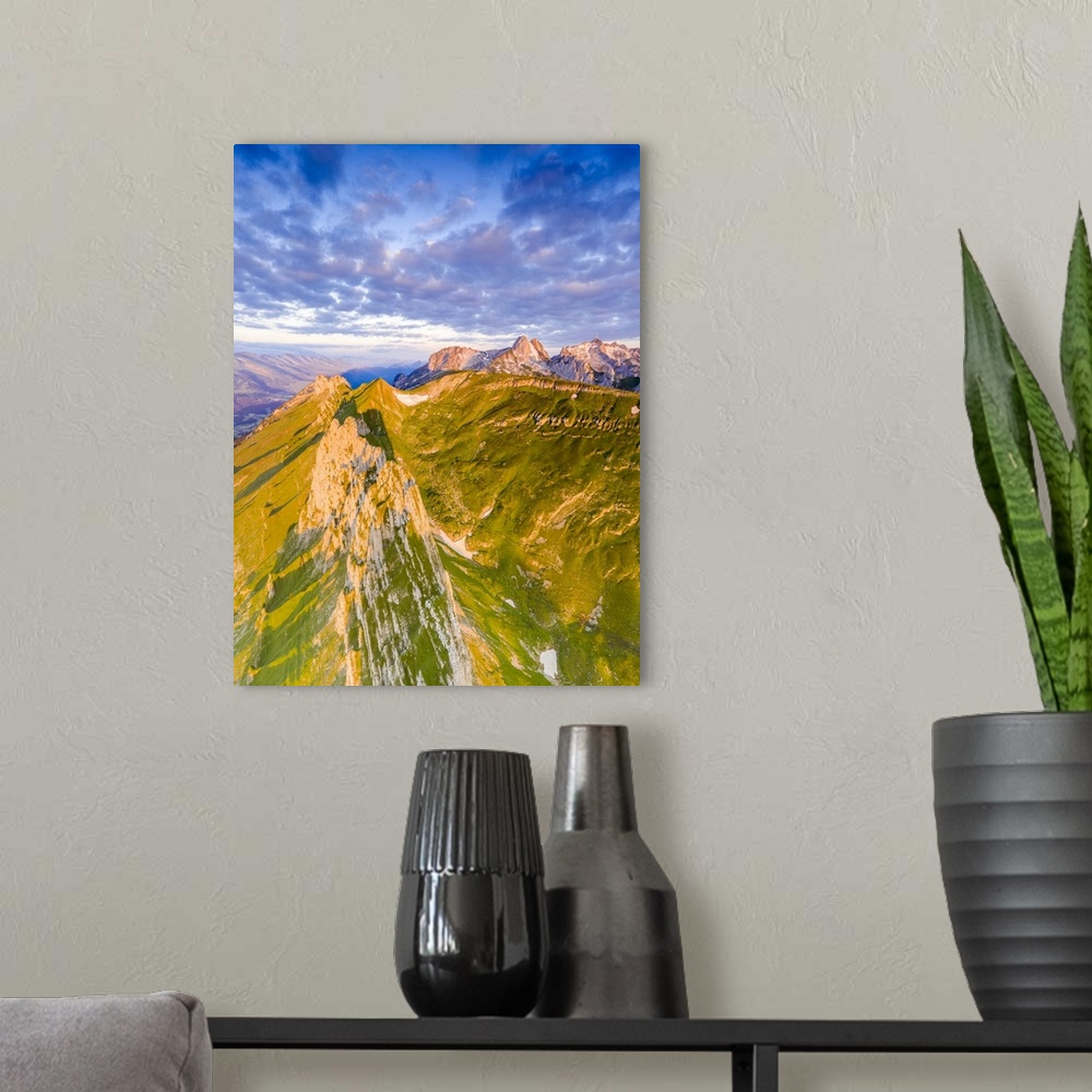 A modern room featuring Clouds at dawn over the majestic peaks of Santis and Saxer Lucke, aerial view, Appenzell Canton, ...
