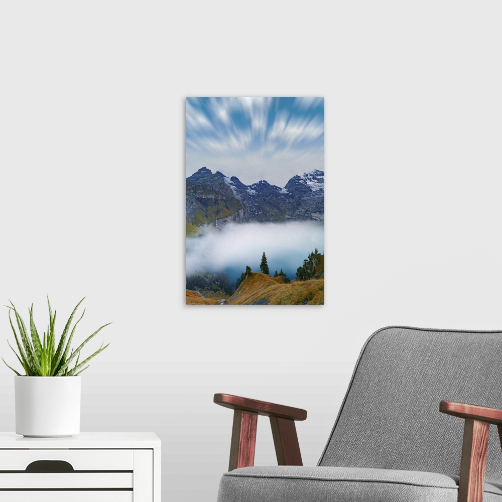A modern room featuring Clouds in the sky above lake Oeschinensee covered by fog, Bernese Oberland, Kandersteg, canton of...