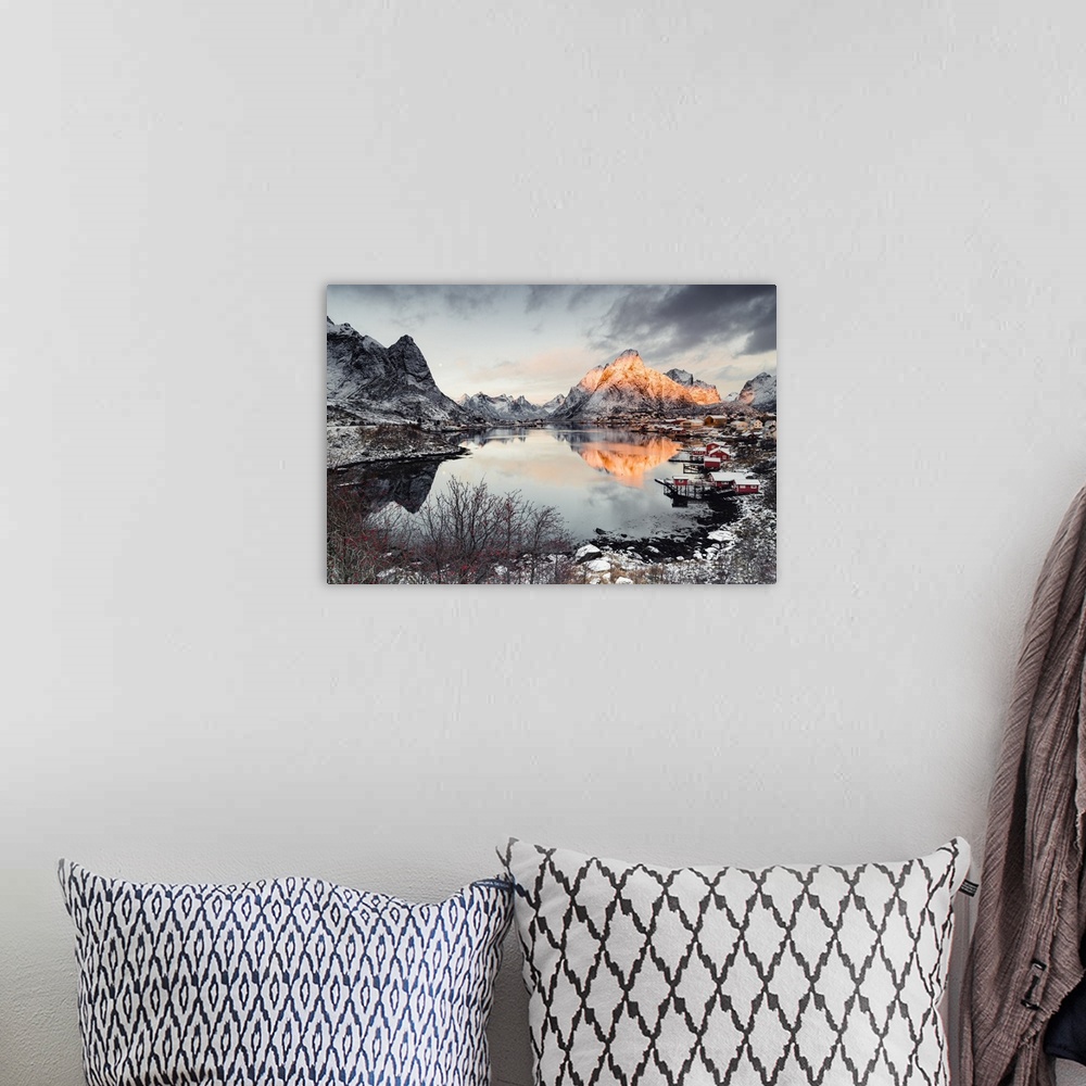 A bohemian room featuring Clouds at dawn over traditional Rorbu and Olstind mountain reflected in sea, Reine Bay, Nordland,...
