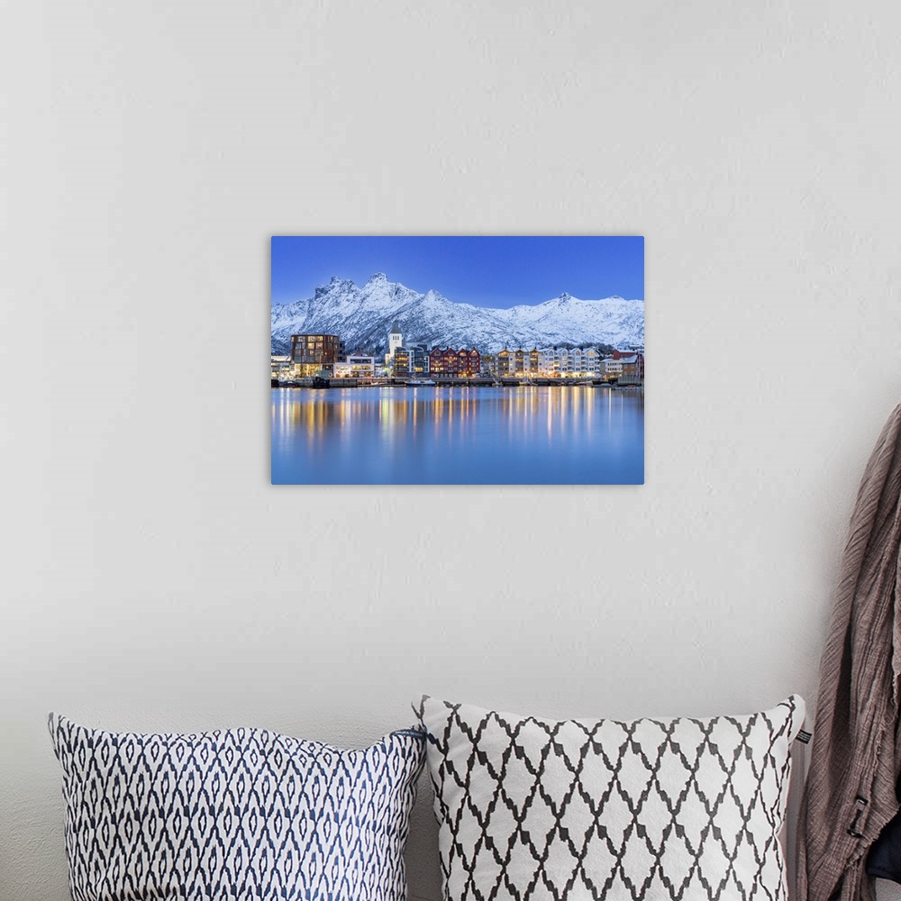 A bohemian room featuring Coastal town of Svolvaer framed by snowcapped mountains at dusk, Nordland county, Lofoten Islands...