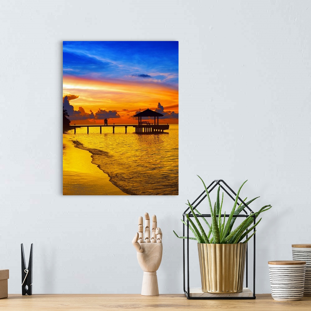A bohemian room featuring Couple on jetty looking at sunset, The Maldives, Indian Ocean, Asia