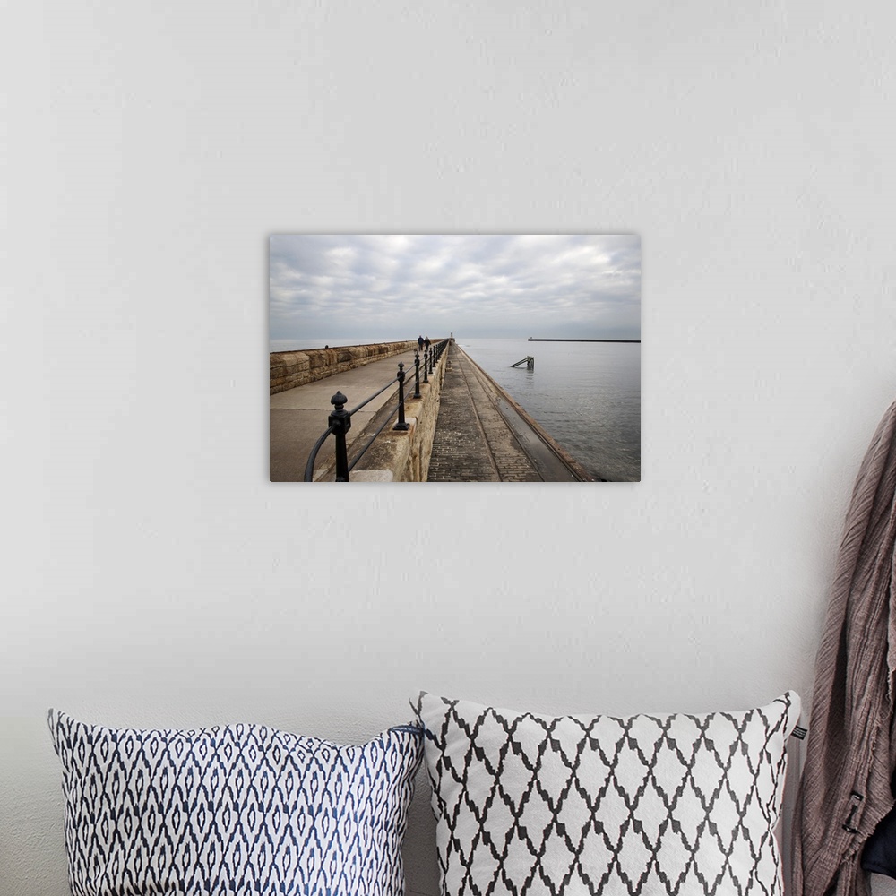 A bohemian room featuring Couple walking on the North Pier at Tynemouth, North Tyneside, Tyne and Wear, England