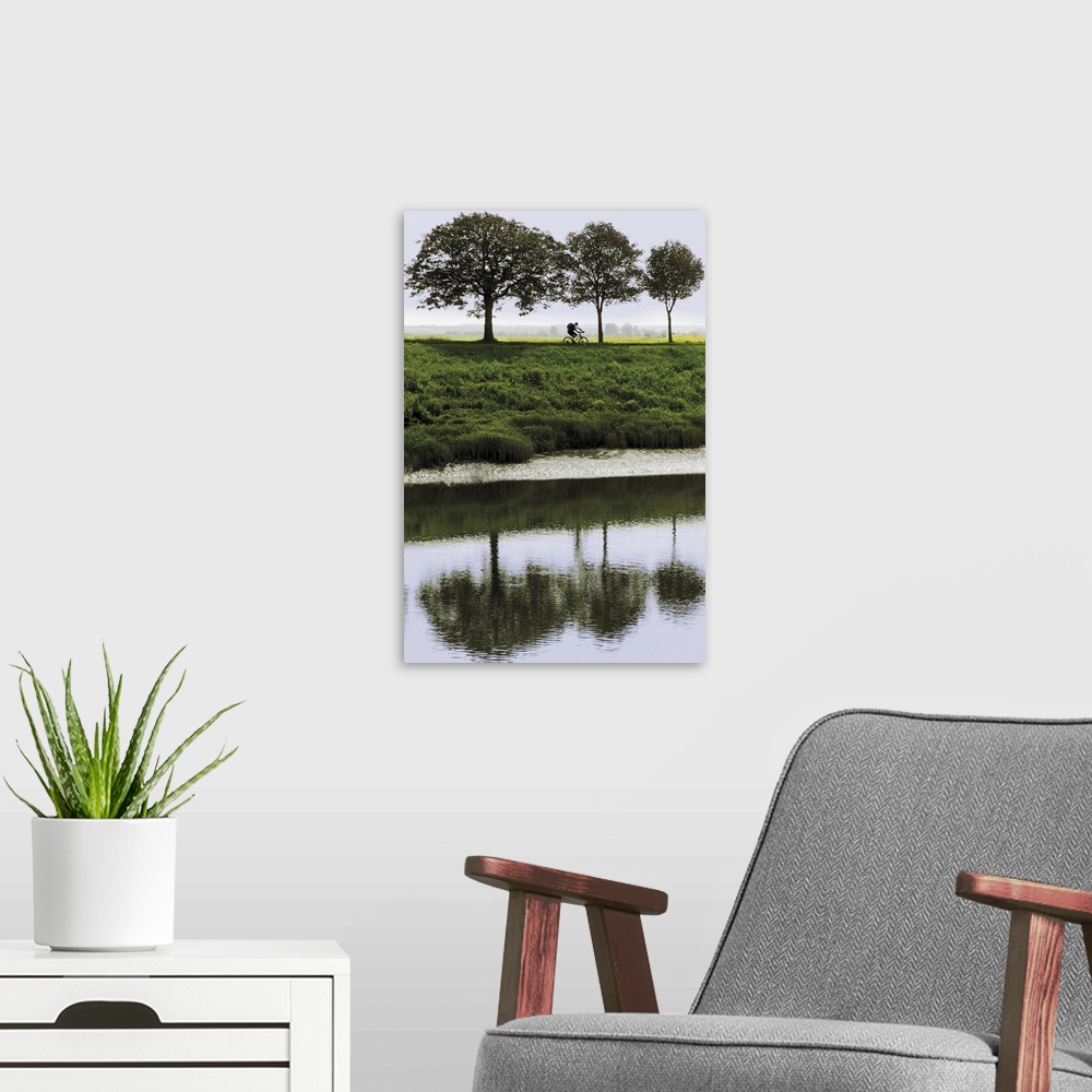 A modern room featuring Cyclist on banks of River Somme, St. Valery sur Somme, Picardy, France