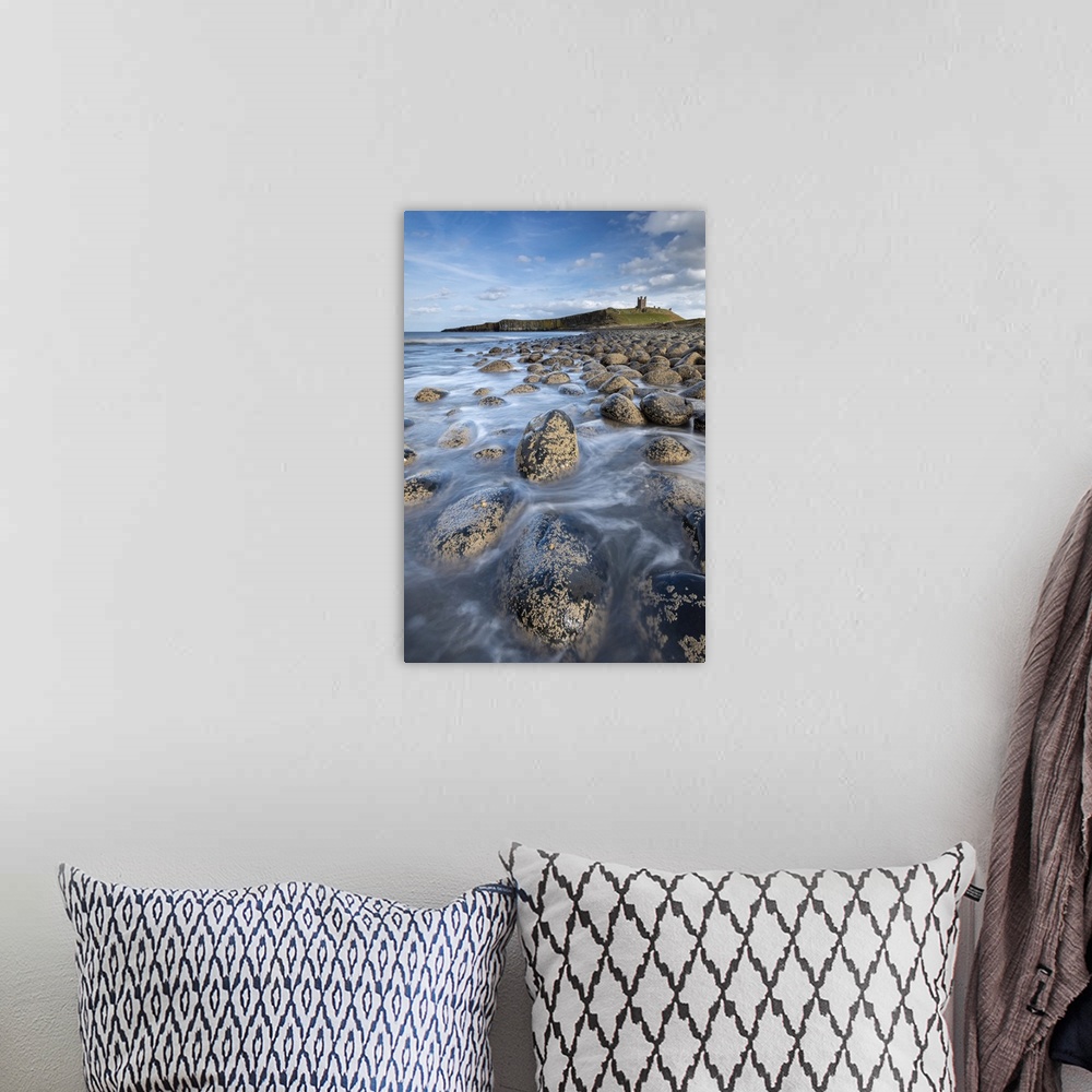 A bohemian room featuring Dunstanburgh Castle from the rocky shores of Embleton Bay, Northumberland, England, United Kingdo...