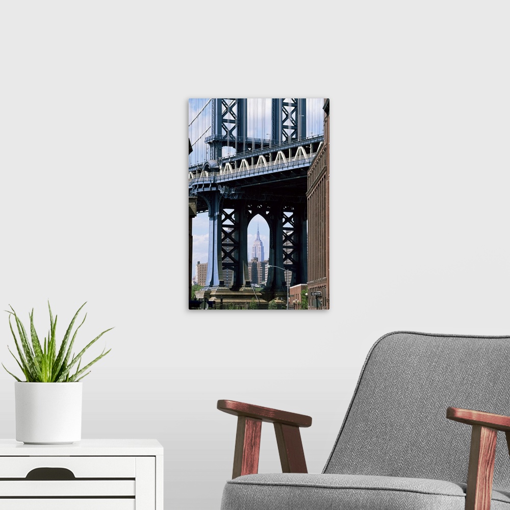 A modern room featuring Empire State Building seen through the Manhattan Bridge, Brooklyn, NYC