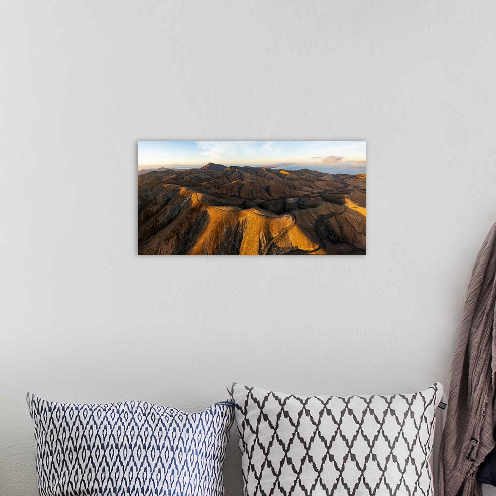 A bohemian room featuring Empty road crossing the barren mountains of Pajara at dawn from Sicasumbre observatory, Fuerteven...