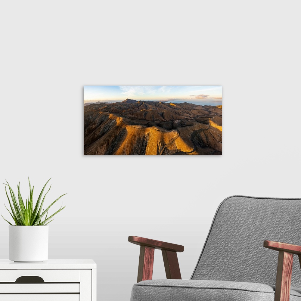 A modern room featuring Empty road crossing the barren mountains of Pajara at dawn from Sicasumbre observatory, Fuerteven...