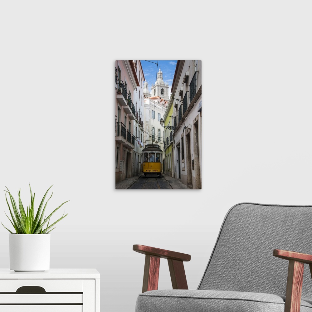 A modern room featuring Famous tram 28 going through the old quarter of Alfama, Lisbon, Portugal, Europe.