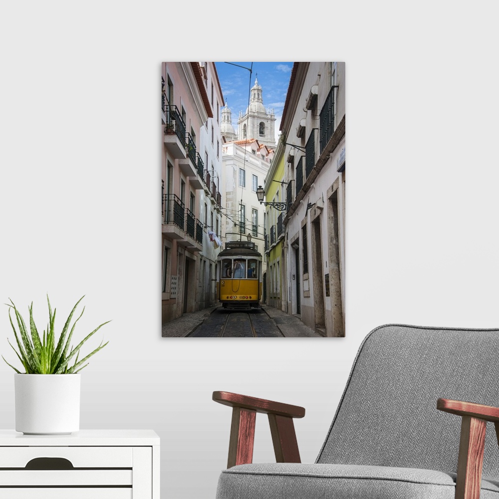 A modern room featuring Famous tram 28 going through the old quarter of Alfama, Lisbon, Portugal, Europe.