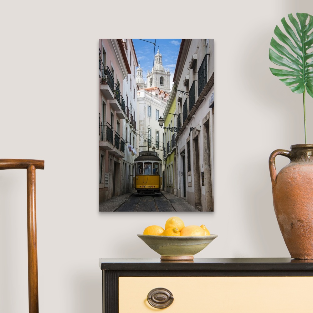 A traditional room featuring Famous tram 28 going through the old quarter of Alfama, Lisbon, Portugal, Europe.