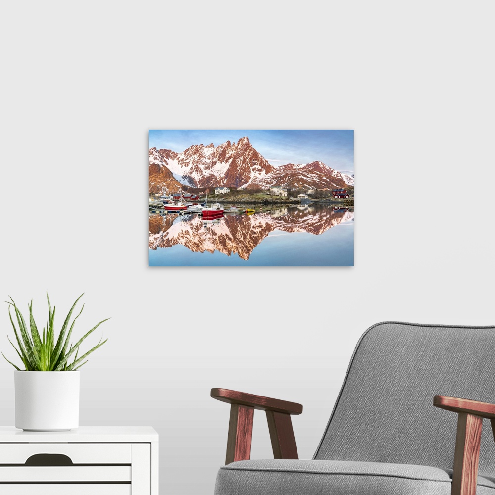 A modern room featuring Fishing boats and snowcapped mountains mirrored in the fjord at sunrise, Ballstad, Vestvagoy, Lof...