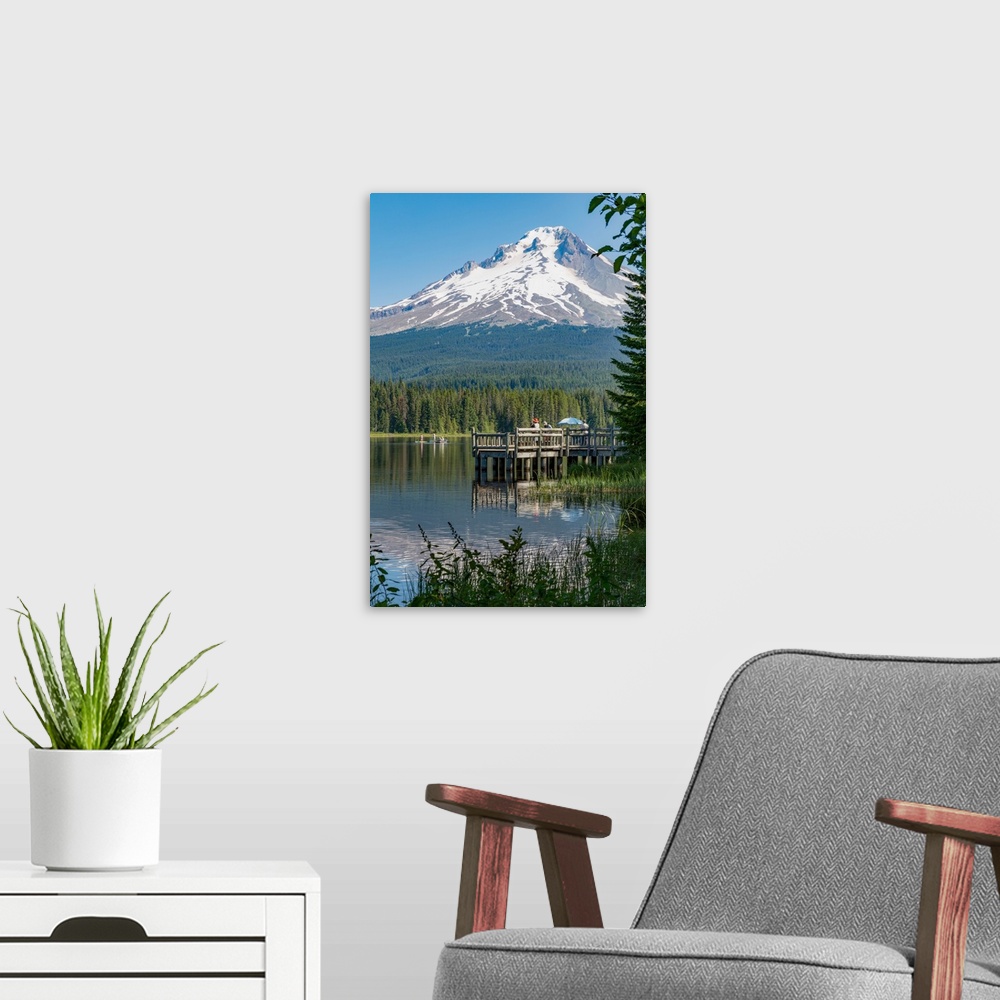 A modern room featuring Fishing on Trillium Lake with Mount Hood, part of the Cascade Range, reflected in the still water...