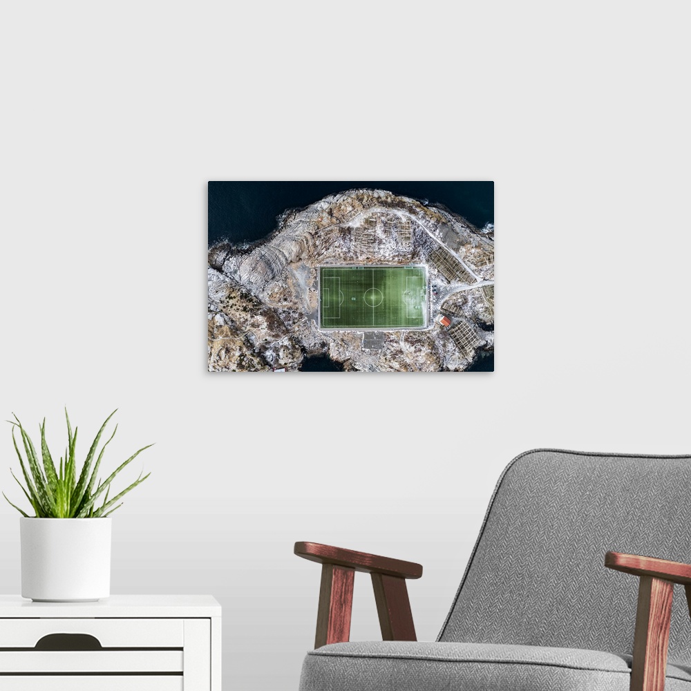 A modern room featuring Football field on islet from above, aerial view, Henningsvaer, Nordland county, Lofoten Islands, ...